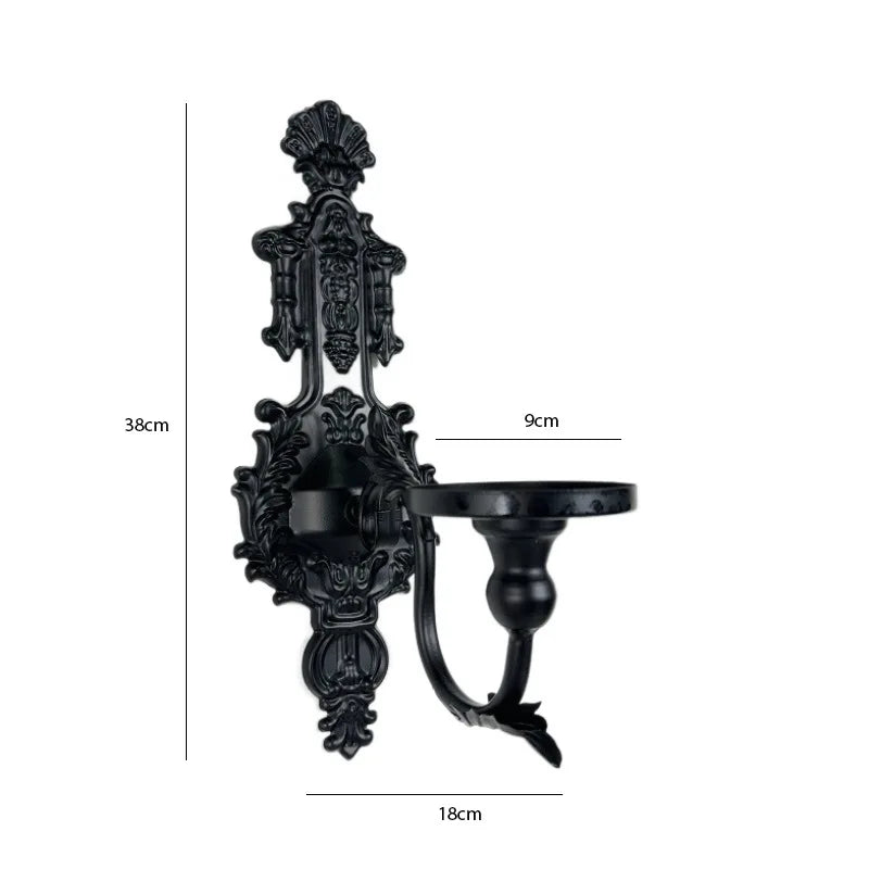 Vintage black wall-mounted double candle holder with ornate detailing