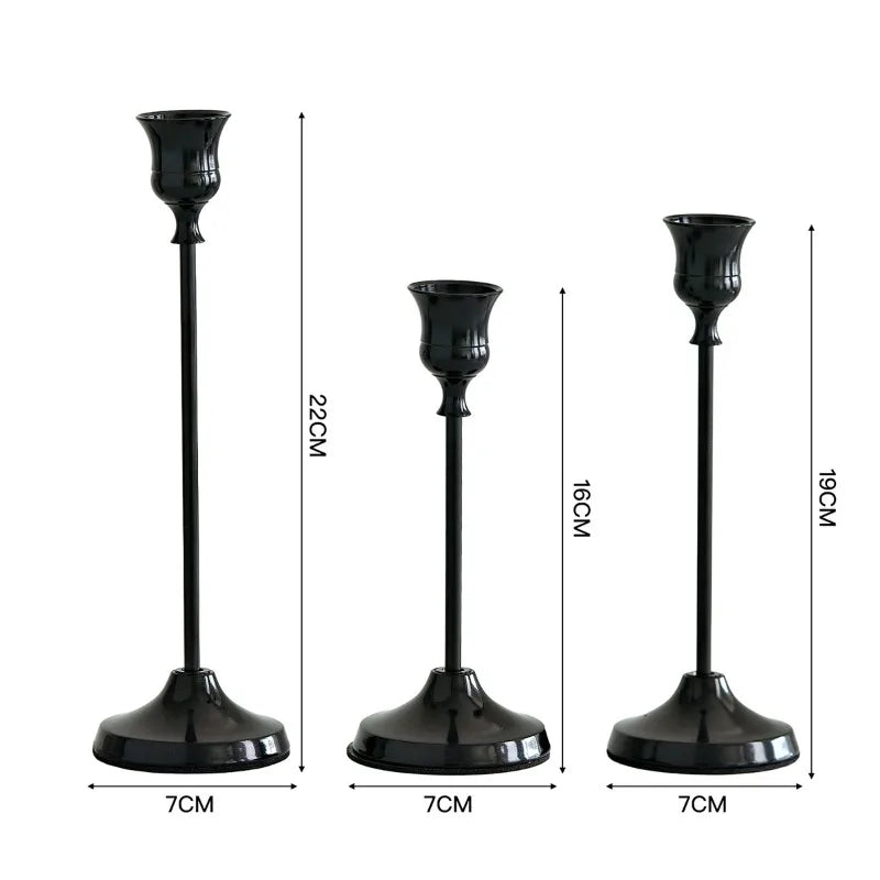 Set of three elegant black metal candlesticks for wedding and holiday décor