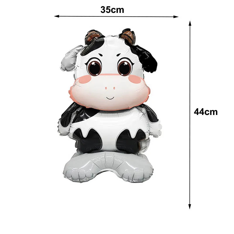A white and black foil balloon shaped like a calf or young bovine animal.