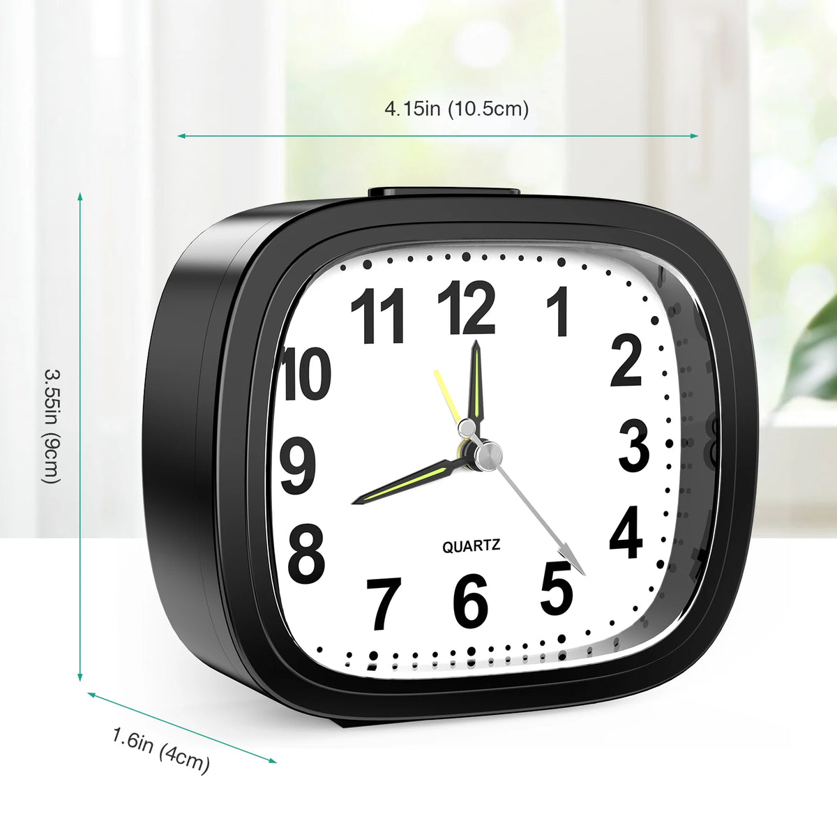 A black quartz analog alarm clock with a luminous display showing the time and hands.