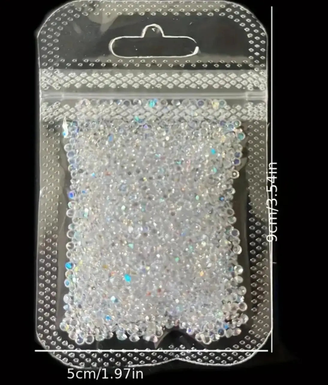 A clear plastic pouch filled with iridescent nail rhinestones for DIY art.