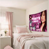 A pink leopard print tapestry wall hanging featuring a woman with long dark hair and pink accents.