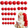 A set of red foam cake toppers, including round and petal shapes, displayed on white sticks.