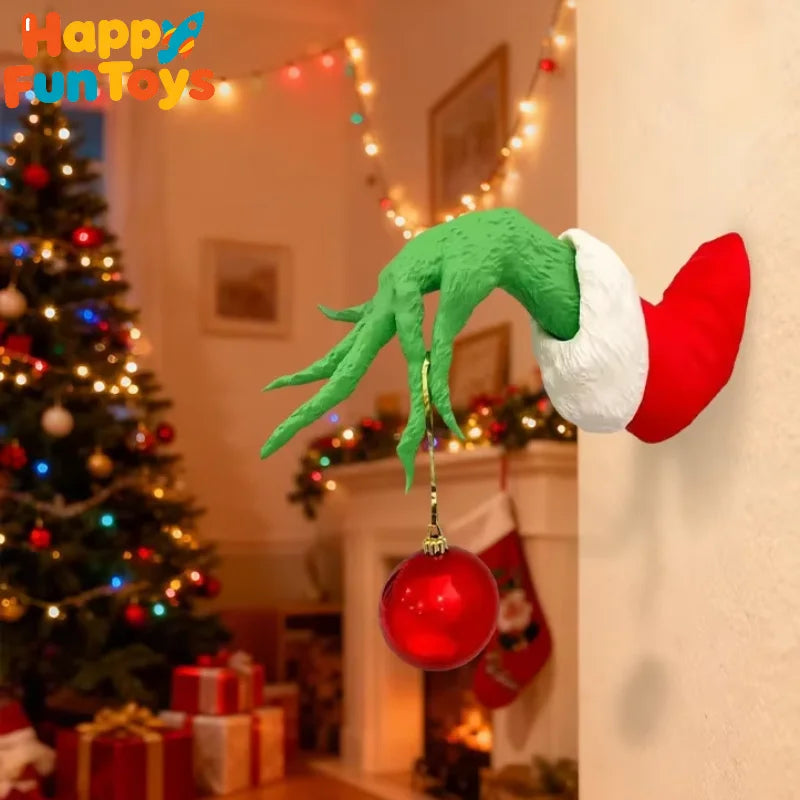 A green monster arm with a red and white Santa hat is displayed as wall decor.