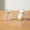 Clear capsule cat whisker keepsake magnet with a white cat figure.