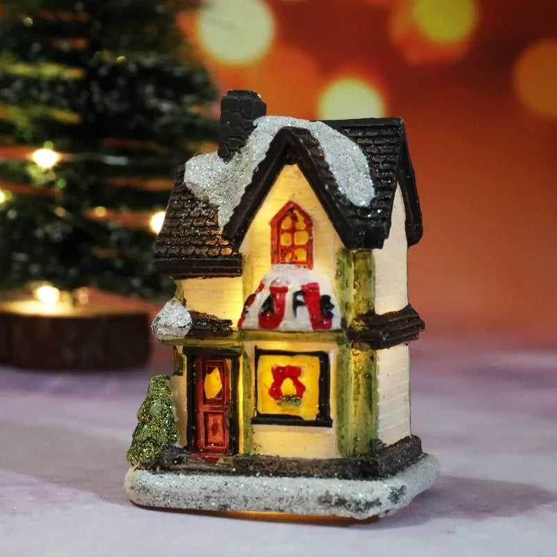 A festive Christmas house night light featuring a detailed miniature house with warm LED glow and snow on the roof.