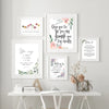 A collection of four framed canvas prints featuring Spanish Bible verses on a white wall.