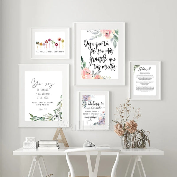 A collection of four framed canvas prints featuring Spanish Bible verses on a white wall.