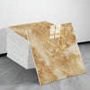 A rectangular sheet of beige and gold marble tile stickers is displayed next to a stack of white tiles.