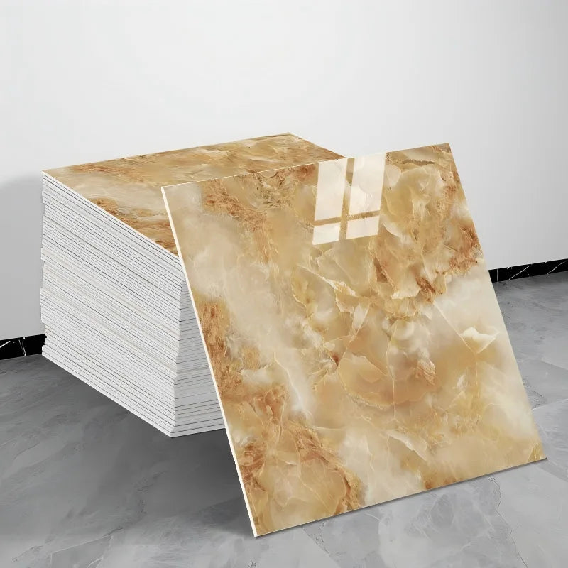 A rectangular sheet of beige and gold marble tile stickers is displayed next to a stack of white tiles.
