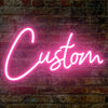 A glowing pink neon sign spelling the word Custom is mounted on a brick wall.