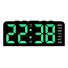 A black digital alarm clock displaying 22:38 with green LED numbers and day of the week indicators.