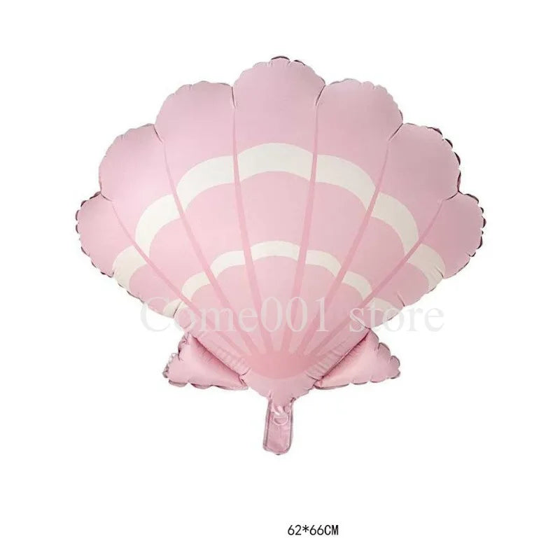 Pink mermaid tail foil balloon decoration with dolphin and seashell accents