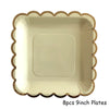 Eight 9-inch gold disposable plates with scalloped edges.