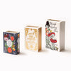 Three ceramic book-shaped vases featuring floral designs and vintage gold accents.