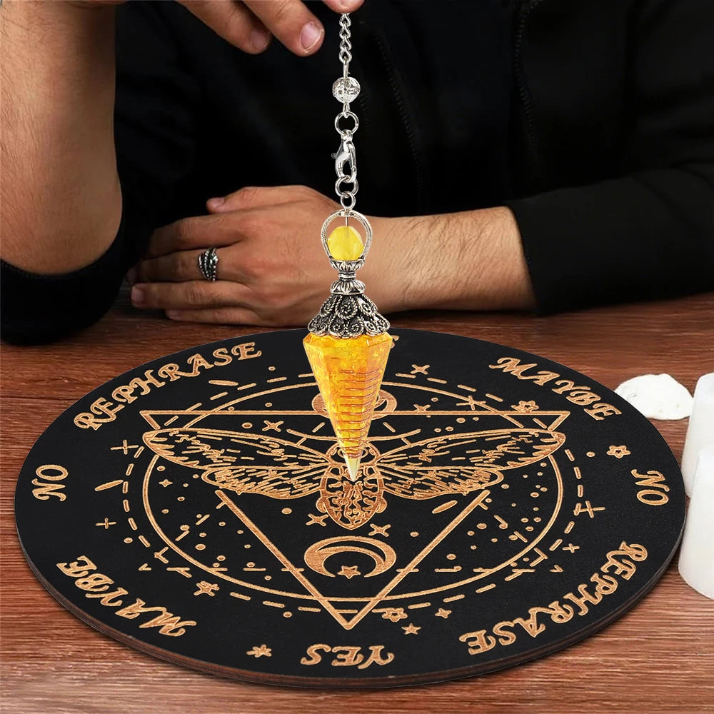 A wooden pendulum board featuring a rose quartz crystal necklace and gold-colored markings.