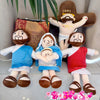 A plush doll set featuring Jesus and Mary figures in soft fabric with religious themes.