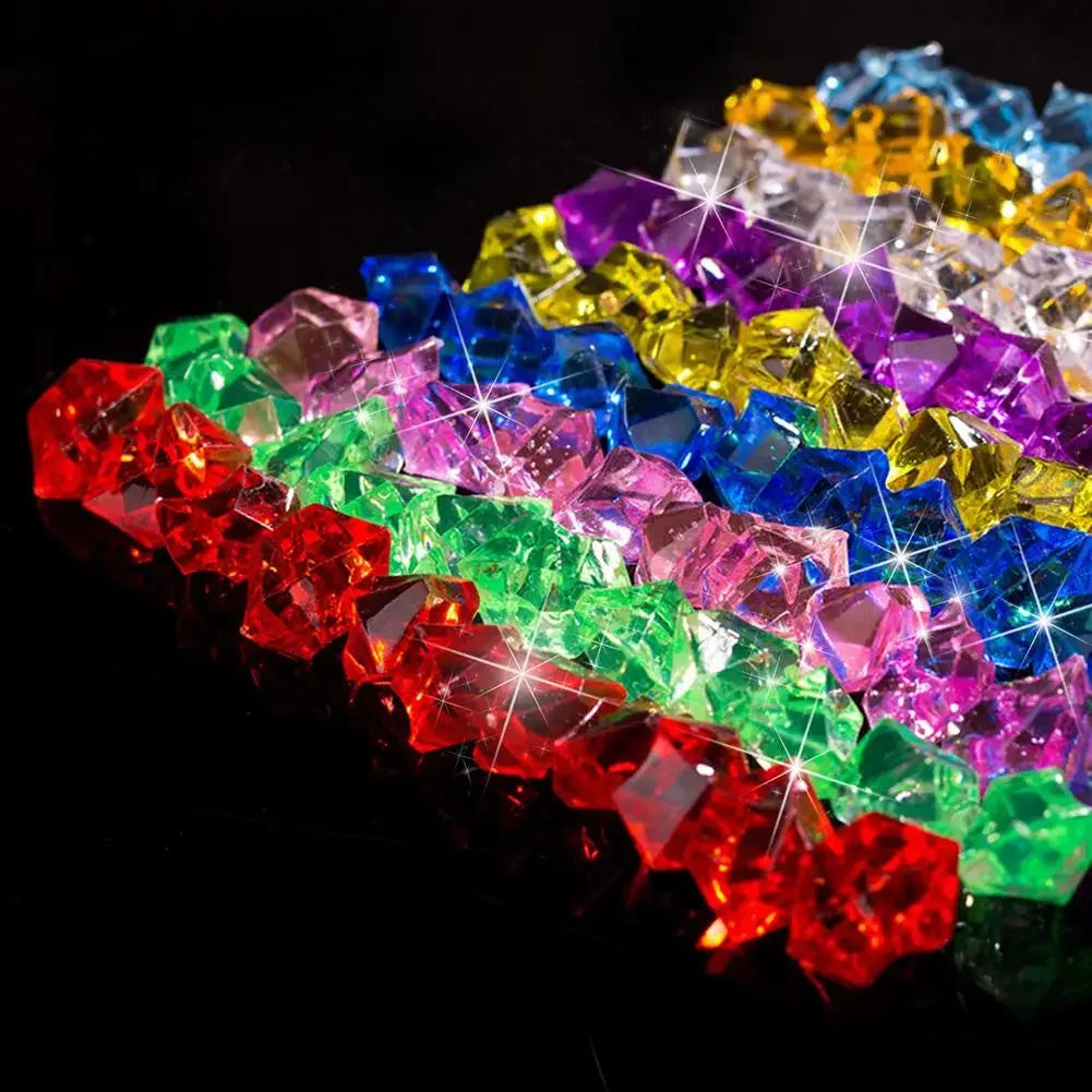 A colorful arrangement of faceted crystal ice cube acrylic stones in various shades of red, green, blue, and purple.