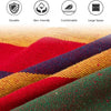 Close-up of a colorful canvas camping hammock fabric showing various red, yellow, and green stripes.