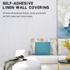 Self-adhesive linen wall covering featuring a 3D texture in shades of blue and beige on a modern interior wall.