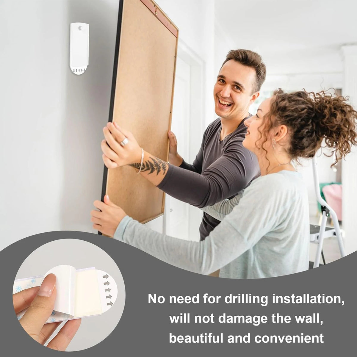 A man and a woman are installing strong self-adhesive picture hanging hooks on a white wall.