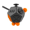 A black fidget cube with orange accents, featuring various textured and moving components for sensory play.