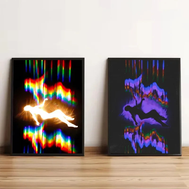 Two framed abstract canvases featuring neon light trails and silhouettes of dancers against a dark background