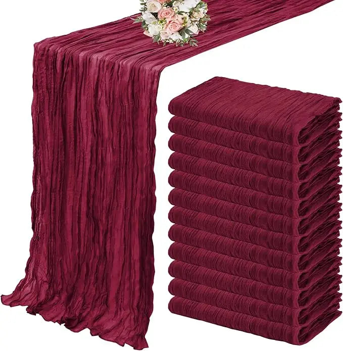 A set of ten terracotta semi-sheer cheesecloth table runners in a deep maroon color.