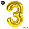 A shiny gold foil number balloon shaped like the number three.
