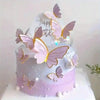 A purple and white cake decorated with pink butterfly toppers and gold accents.