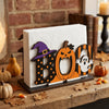 A wooden tissue dispenser shaped like the letter B with a ghost pattern, displayed on a rustic wooden surface.