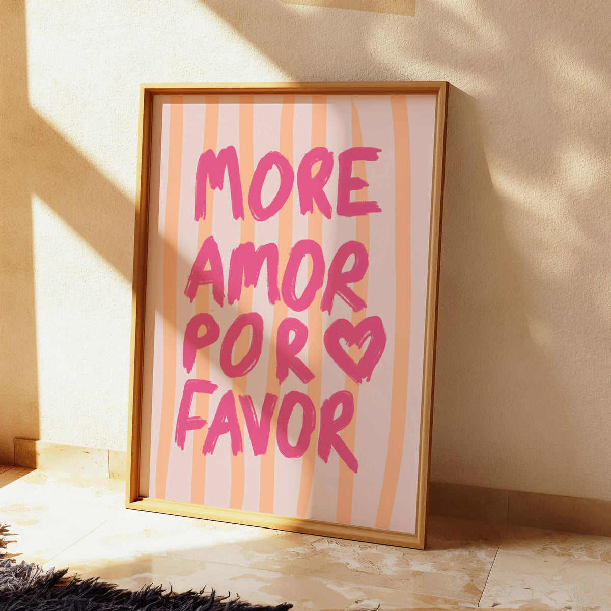 Framed canvas wall art featuring the text MORE AMOR POR FAVOR in pink and orange stripes.