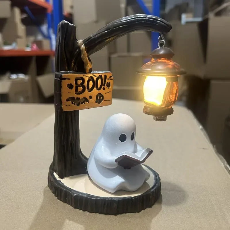 A figurine of a ghost reading a book, positioned beneath a wooden faucet with a hanging lantern.