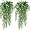 A set of three lifelike faux eucalyptus hanging plants with green leaves and white flowers.