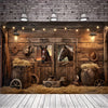 A rustic wooden barn door background featuring a saddle and horse silhouettes, illuminated by hanging lights.