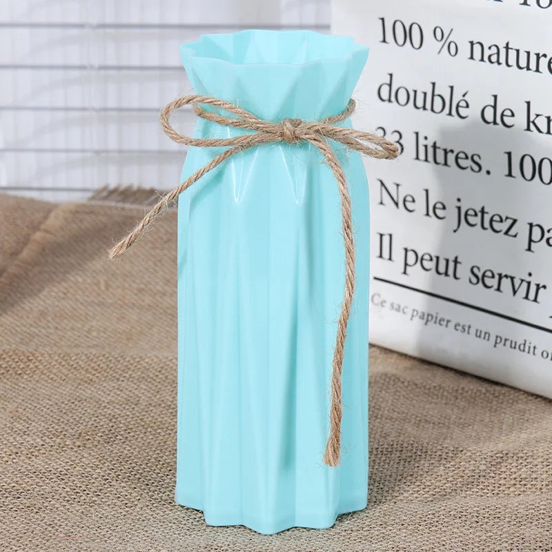 Light blue plastic vase with a natural twine bow tied around the neck