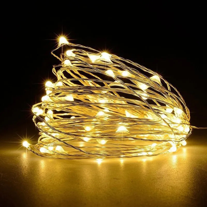 A bundle of warm yellow fairy string lights creating a bright, glowing effect against a dark background.