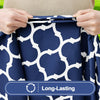 Hands holding a navy blue and white patterned waterproof elastic fitted tablecloth