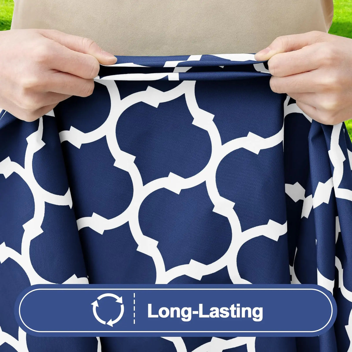 Hands holding a navy blue and white patterned waterproof elastic fitted tablecloth