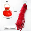 A red paper streamer with a white loop and brown trim, shown next to a long strand of 30 pieces of red ribbons.