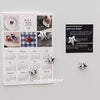 A monthly calendar featuring silver star designs and decorative fridge magnets.