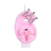 Pink felt candle shaped like a crown with a bow and a crown topper for a birthday cake.
