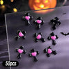 A variety pack of 50 black and pink Halloween themed resin nail charms shaped like crosses.