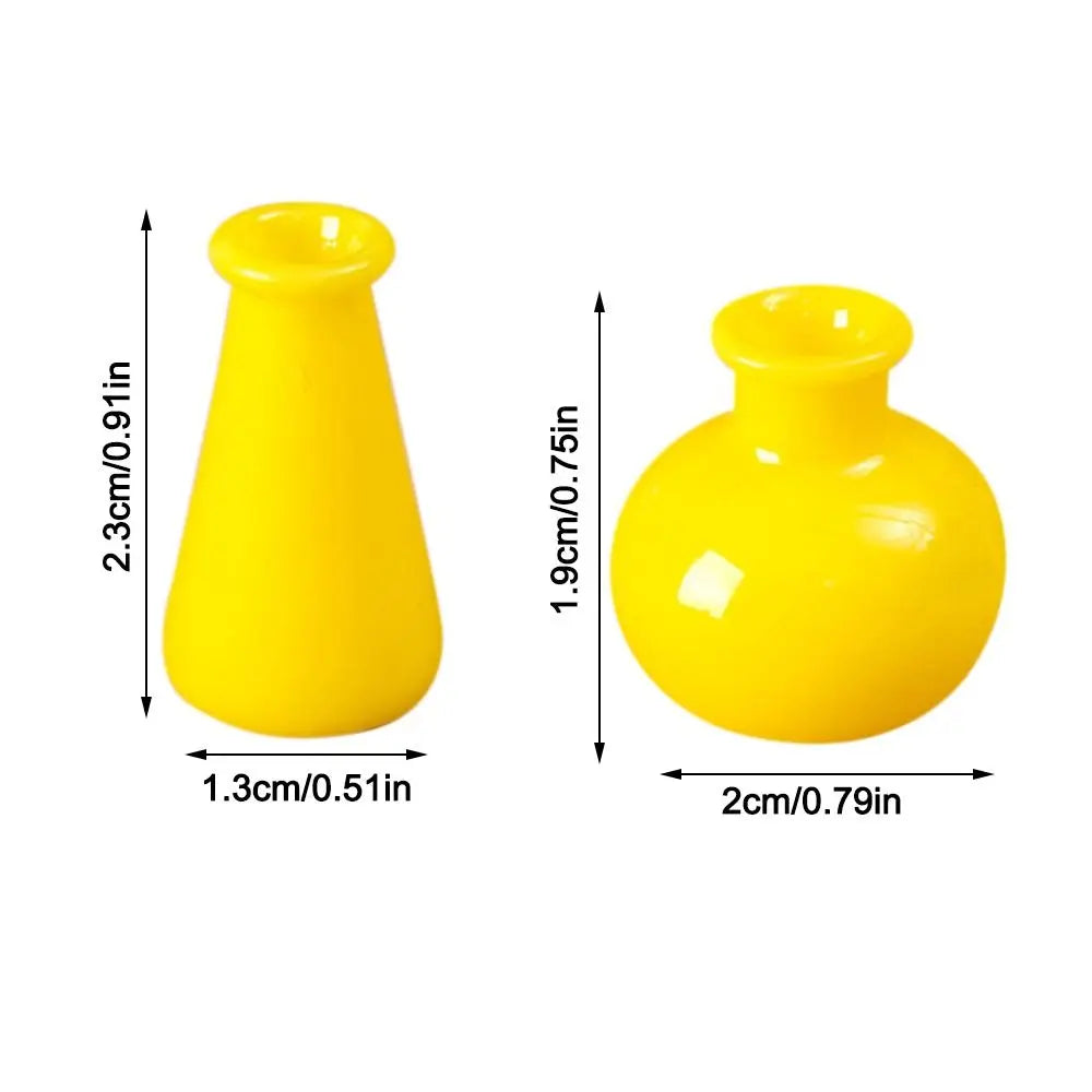 A bright yellow miniature resin vase with a flared neck and round body.