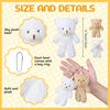 A set of white and tan plush teddy bears with key rings shown next to a hand.