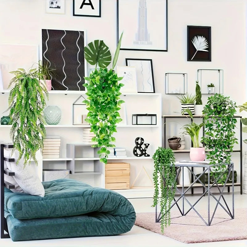 A set of four artificial eucalyptus hanging vines displayed on a white shelf with various plants and decor.