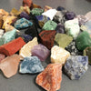 Assorted mixed natural raw crystal stones and healing minerals in various colors and shapes.