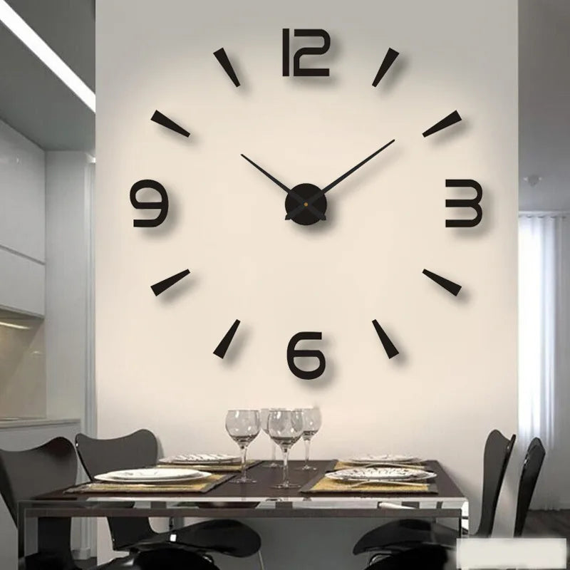 A modern wall clock with black numbers and hands is mounted on a white wall above a dark wooden table.