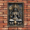 A dark metal statue of Goddess Durga with multiple arms, seated on a skull, set in a decorative frame.