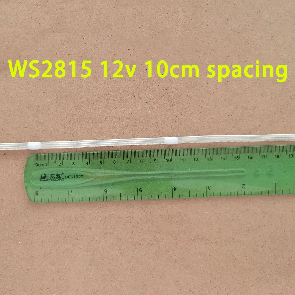 A white LED string light is shown next to a ruler, demonstrating a 10cm spacing.